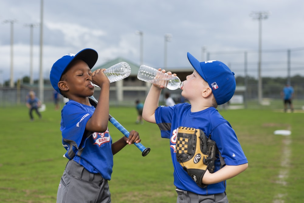 Jugadores de béisbol toman un descanso para hidratarse durante un día caluroso en el campo de juego. Foto: Tyler Jones, UF/IFAS. Florida se encamina a veranos más largos y extremos, revela estudio de UF